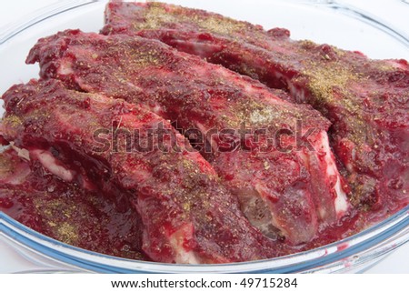 Pork ribs in cranberry sauce on glass dish