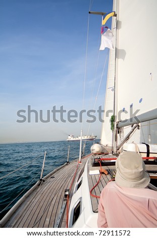 Man on sailing boat in the sea, sunny day