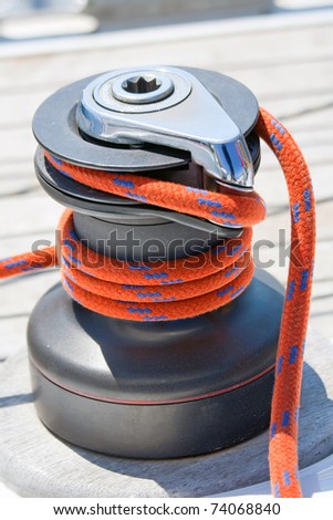 Winch with red rope on sailing boat