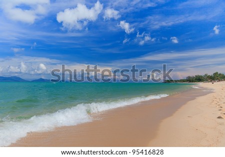 Blue sky and sand beach with wakeboarder sailing in the open sea. Koh Samui, Thailand