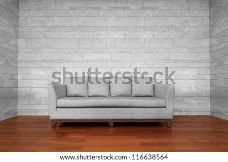 Grey Couch Chair On Brown Wooden Floor And White Wall