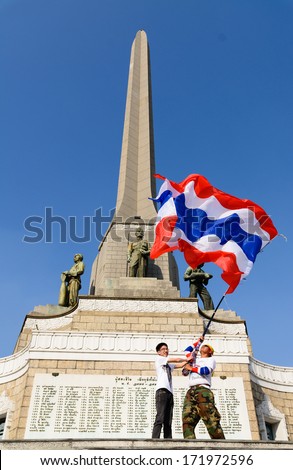 Protester waving Thai flag to protest against the government corruption in  