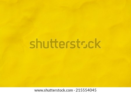 Colorful yellow plasticine clay background