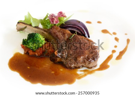 Roast lamb chops with gravy on white background