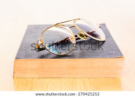 Vintage eye glass on old book