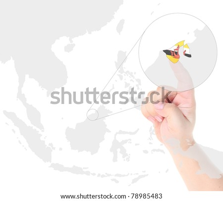 Finger touch on a future innovative transparent screen display Brunei map and flag