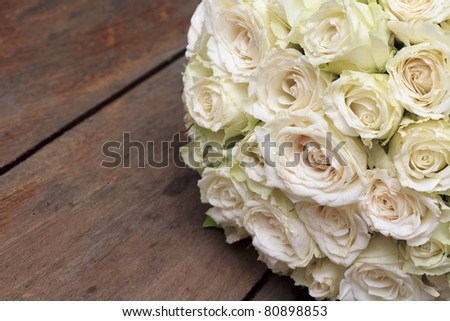 White wedding rose bunch on wooden desk