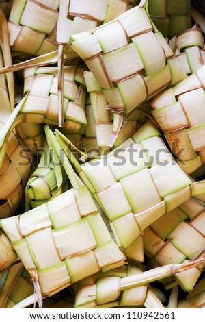Local Delicacy, Ketupat Craft Background. Local put rice inside the craft before cooking Ketupat is traditional food in Malaysia for celebration