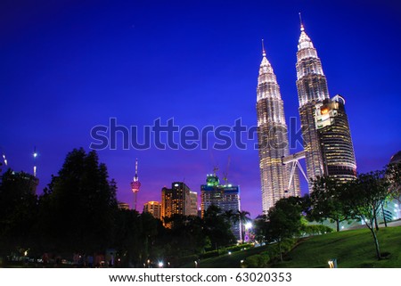 KUALA LUMPUR - OCTOBER 14: Beautiful night lighting of Petronas Twin Towers (KLCC) October 14, 2010 in Kuala Lumpur, Malaysia.  The Petronas Twin Towers remain the tallest twin buildings in the world.
