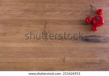 Tomatoes on a worn butcher block counter