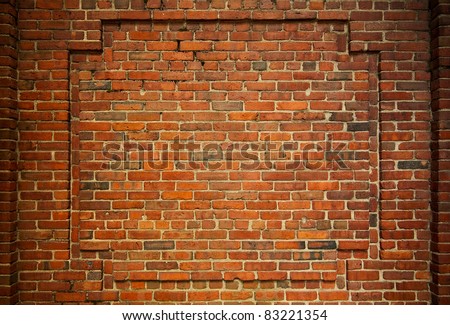 Old brick wall with decorative bricks forming an internal frame