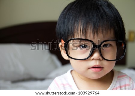 Portrait of a baby girl wearing big spectacles