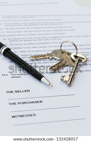 Real estate contract with pen and keys