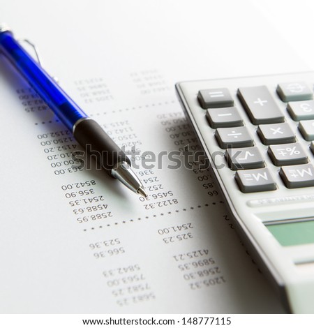 Finance analysis concept using finance report with pen and calculator