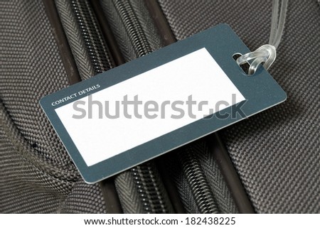 Close up of blank luggage tag on suitcase