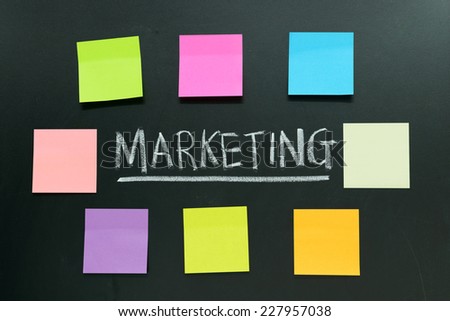 Plain notes surround the word marketing on black background