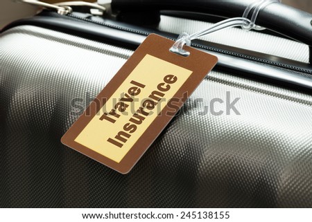 Travel insurance luggage tag tied to a suitcase