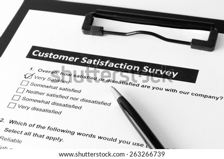 Filling customer satisfactory survey form with pen