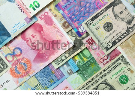 Close up of foreign currency banknotes forming background