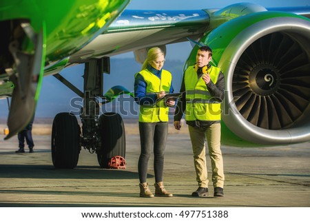 airport workers handling airplane
