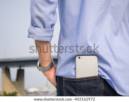 Smart phone in the back pocket of blue jeans