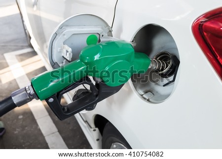 Dispenser pumping diesel or gasoline in car at gas station