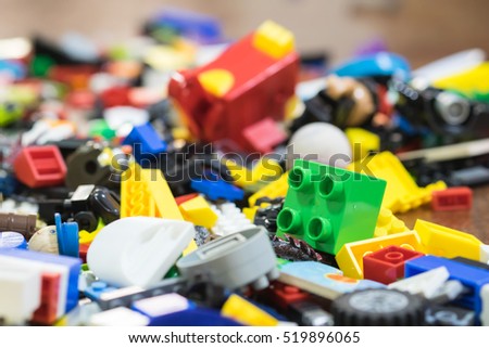 Background of random coloured plastic construction blocks or brick toy.