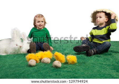 Easter theme with cute small girl and boy with toy bunnies, chicks and eggs.