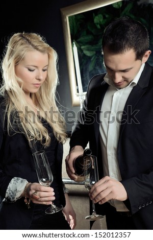 The business couple is preparing the drinks to celebrate there business success.