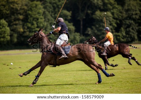 The Polo Player Hits The Ball Towards The Goal.