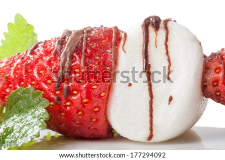 A fresh fruit stick with strawberry and marshmallow.