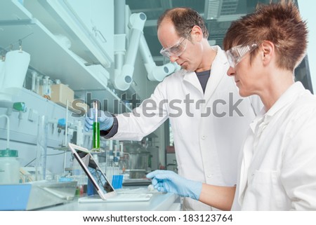 A Team of chemists are analyzing an alga liquid and comparing it with the saved value from the mobil device.