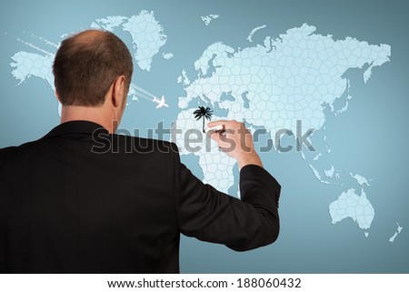 A Businessman is drawing his journey on a world map.