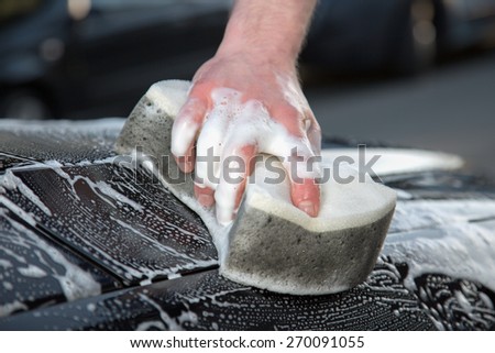 A close view from a car cleaner with a sponge and foam.