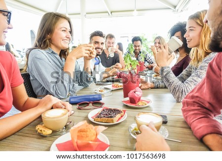 Group of happy friends having coffee break at bar cafeteria - Young students people enjoying breakfast - Friendship and good mood concept - Focus on left woman drinking cappuccino