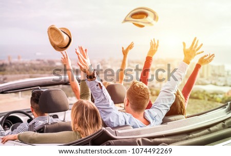 Happy people having fun in convertible car in summer vacation - Young tourist friends traveling in cabriolet auto - Radial purple and green filters editing - Main focus on left blond girl head