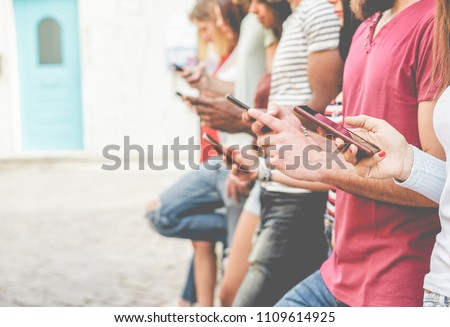 Group of friends watching smart mobile phones - Teenagers addiction to new technology trends - Concept of youth, tech, social and friendship - Focus on close-up phone