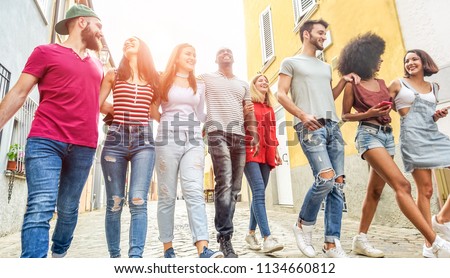 Young millennials friends walking in city old town center - Happy people having fun together - Youth lifestyle, generation z and friendship concept - Main focus on left girl face