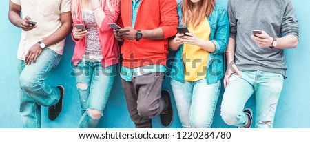 Group of friends watching smart mobile phones - Teenagers addiction to new technology trends - Concept of youth, tech, social and friendship - Main focus on center hands
