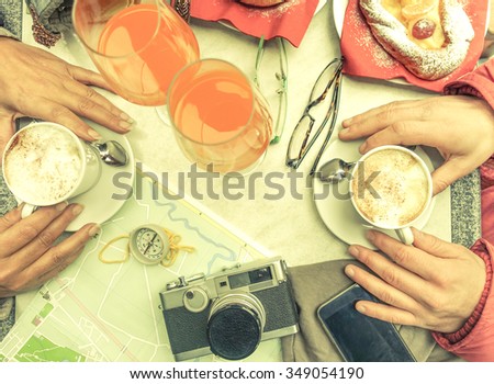 Multiracial couple eating and drinking at coffee bar restaurants - People hands with smartphone and old camera with upper point of view - Technology and breakfast concept  - Vintage filter