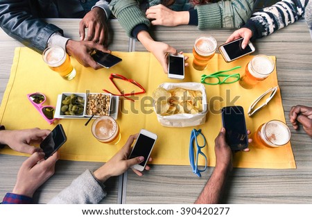 Group of friends having fun together with smartphones making aperitif - Closeup of hands social networking with mobile cellphones - Technology and phone addiction concept - Main focus in the middle