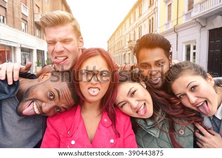 Multiracial best friends taking selfie outdoors in urban contest - Happy young people having fun together - Multi ethnic and Friendship concept - Soft vintage warm filtered look
