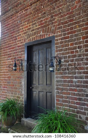 Black front door on a red brick house