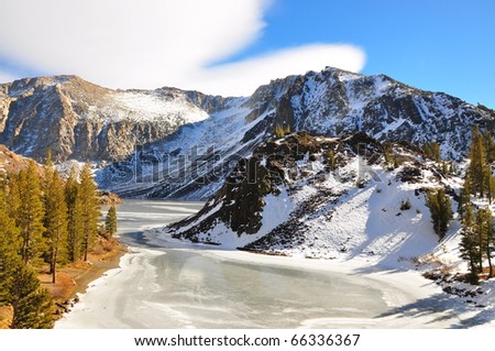 Mountain Snow Scene and a frozen lake on the Tioga Pass, California