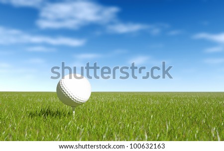 Golf ball on tee green grass and blue sky.