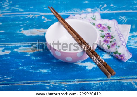 Empty bowl of rice on vintage blue wooden table