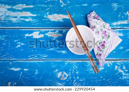 Empty bowl of rice on vintage blue wooden table