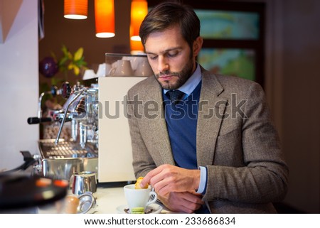 Business man in coffee shop, drinking espresso
