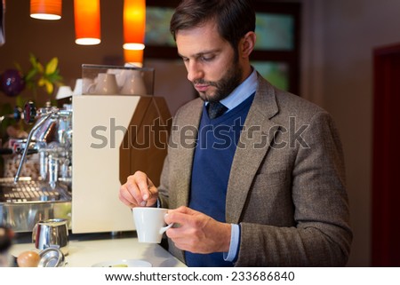 Business man in coffee shop, drinking espresso