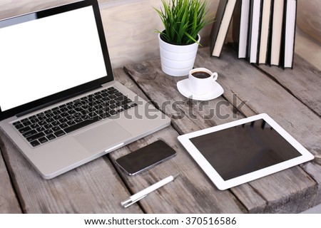 PC laptop, tablet and phone on wooden table